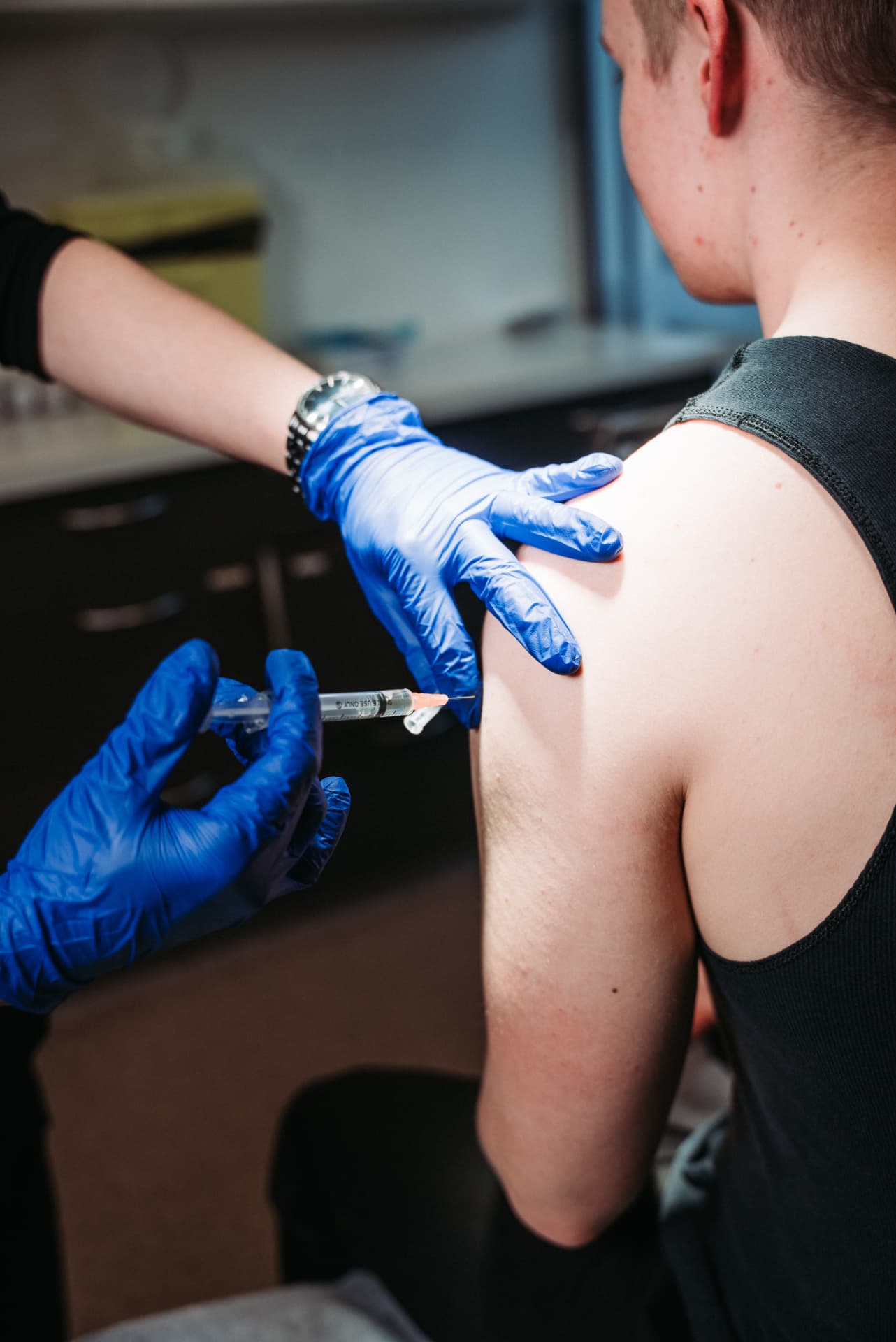 Dr William Fong administering a travel vaccination