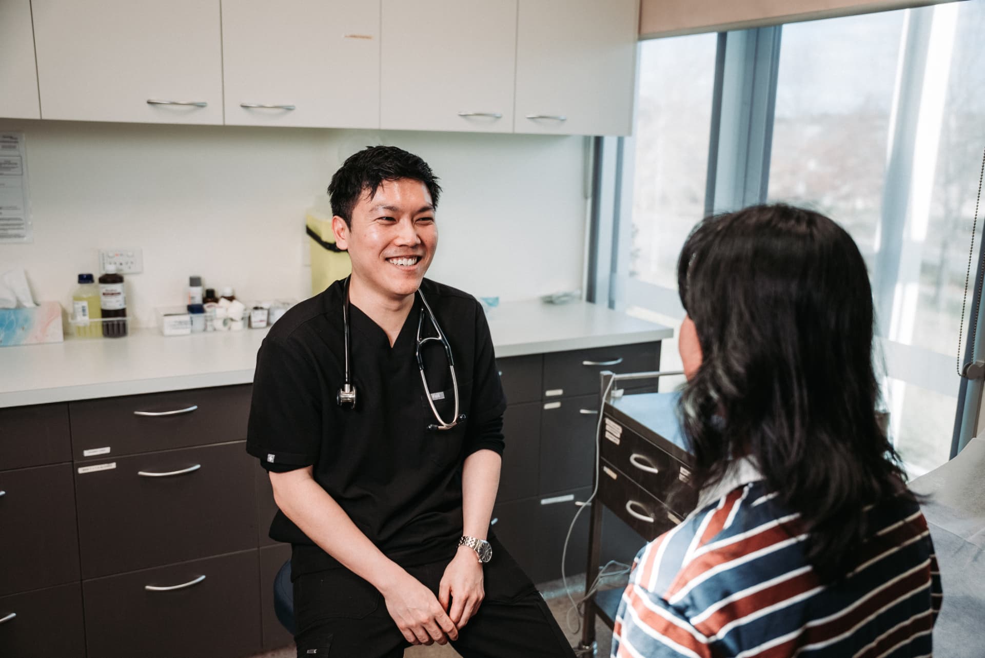 Dr William Fong consulting with a patient in a calm clinic setting