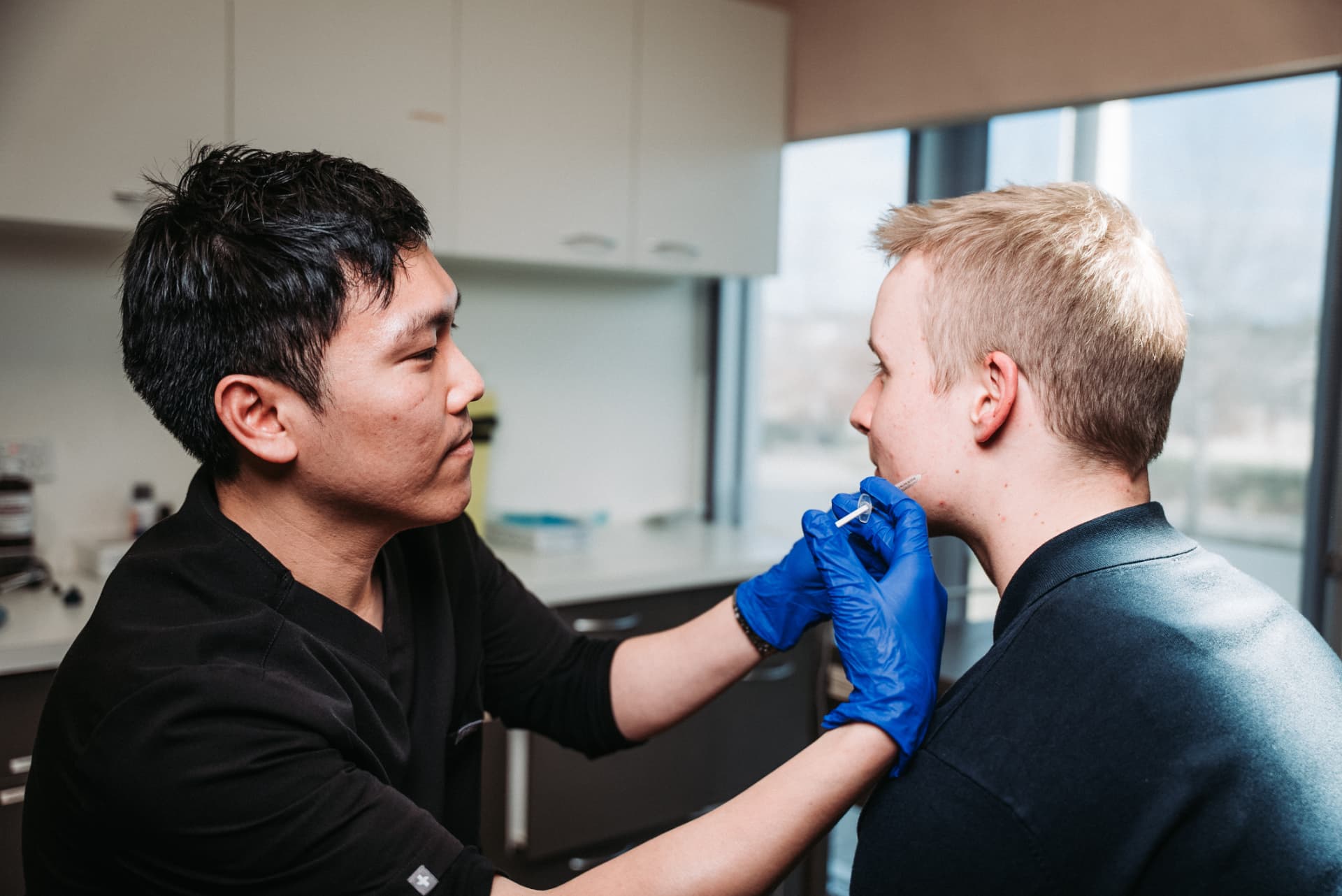 Dr William Fong performing an aesthetic skin treatment
